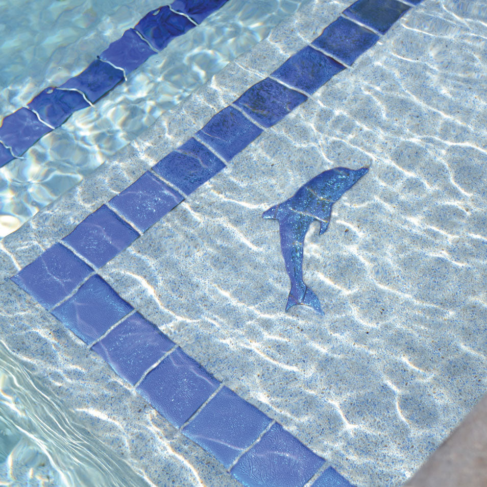 Blue dolphin mosaic on a pool floor with tiled border