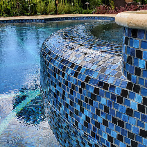 Moonscape Light Blue 1x1 Glass Tile Installed Around Spa and Waterline