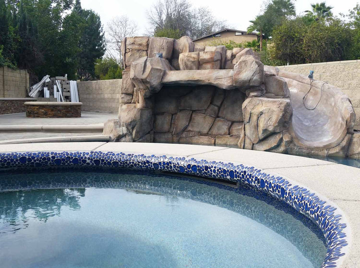 Royal Blue Glossy Porcelain Tile Installed Around a Spa Next to Slide