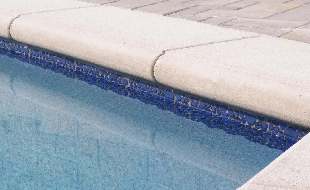 Royal Blue Glossy Porcelain Tile Installed on The Swimming Pools Waterline