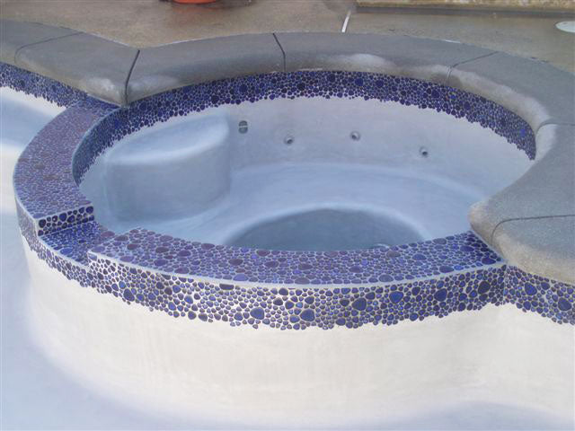 Royal Blue Pebble Stone Installed Around the Spa Before