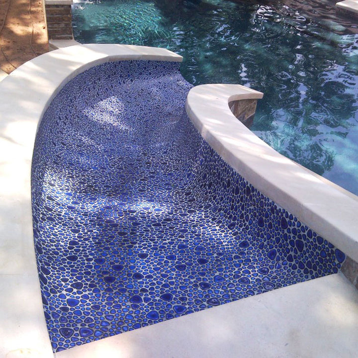 Royal Blue Pebble Stone Installed on a Pool Slide