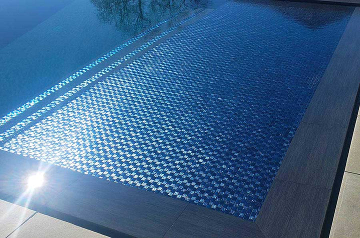 Lustrous Blue 1x1 Glass Tile Installed on a Tanning Ledge